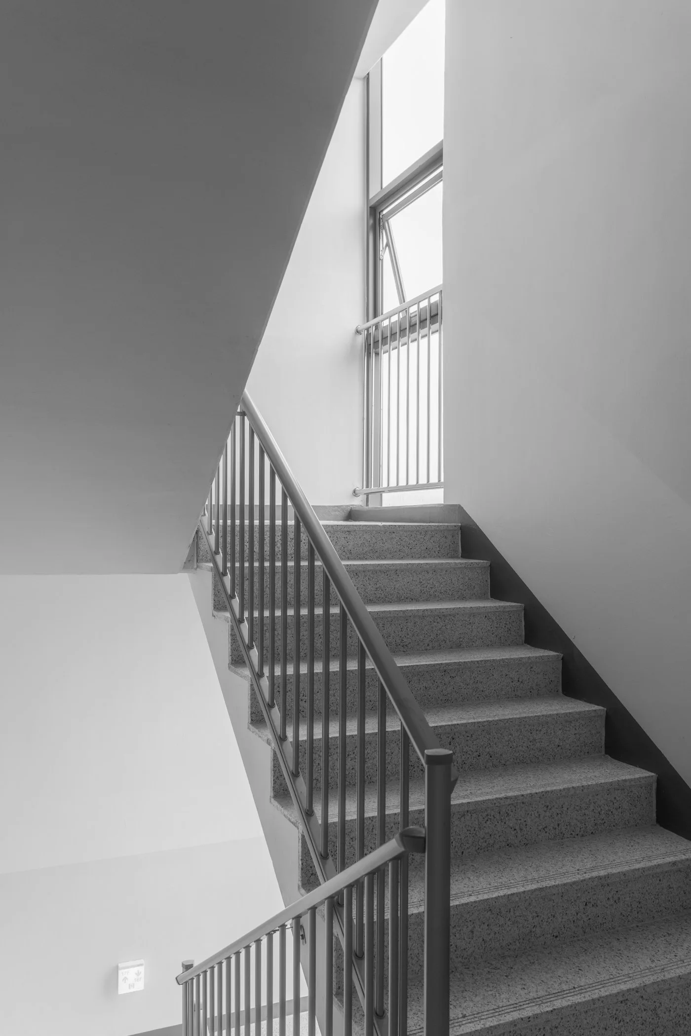 Black and white photograph of a curved staircase